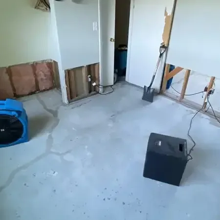 Air movers and a dehumidifier drying a room with lower drywall removed, a Villa Park service