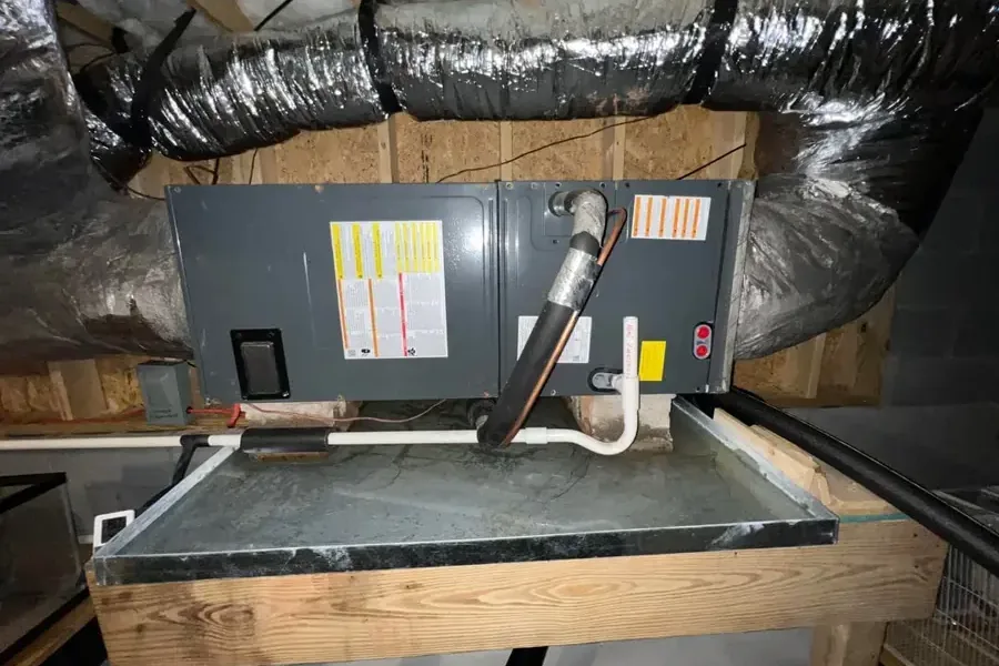 Attic air handler with its condensate drain pipe