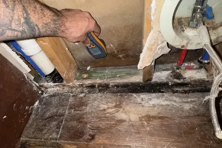 Wall opened to expose the water pipes after a pipe burst inside a house