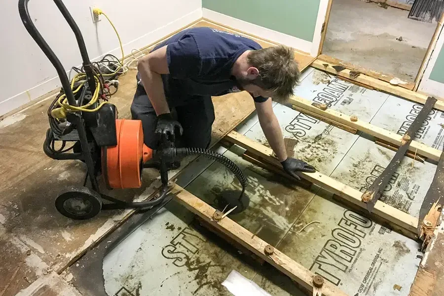 Drain pipe being cleared during a sewage backup cleanup
