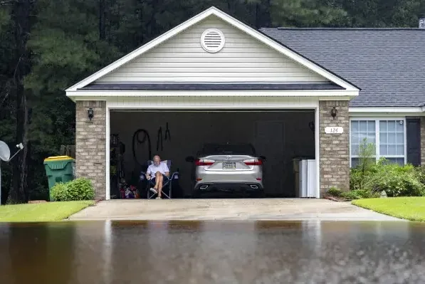 Storm runoff flooding a driveway and running into an attached garage
