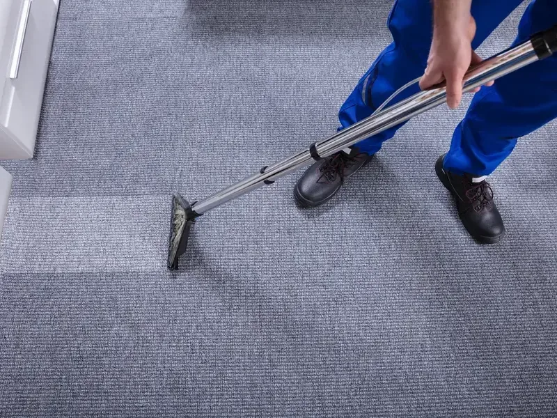 Extraction wand drawing water out of soaked carpet during a water removal